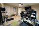 View of workout area with treadmill, exercise bench, wall-mounted TV and access to other rooms at 3205 Anneewakee Falls Pkwy, Douglasville, GA 30135