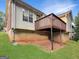 House backyard featuring a wooden deck with brown railings and a well-maintained green lawn at 106 Oakwood Cir, Stockbridge, GA 30281