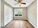 Bright, neutral bedroom with wood floors, a ceiling fan, and closet for ample storage and comfort at 106 Oakwood Cir, Stockbridge, GA 30281