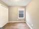 Bright bedroom with neutral walls, wood flooring, and a window providing natural light at 106 Oakwood Cir, Stockbridge, GA 30281