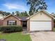 Charming one-story brick home with a well-maintained lawn and attached two-car garage at 106 Oakwood Cir, Stockbridge, GA 30281