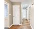 Inviting hallway with neutral walls and wood-look flooring, offering a seamless transition between rooms at 106 Oakwood Cir, Stockbridge, GA 30281
