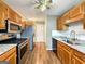Kitchen with stainless steel appliances, wood cabinets, and updated granite countertops at 106 Oakwood Cir, Stockbridge, GA 30281
