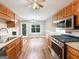 Spacious kitchen with stainless steel appliances, wood cabinetry, and eat-in dining area at 106 Oakwood Cir, Stockbridge, GA 30281