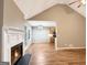 Open-concept living room with fireplace, wood floors, and view of the kitchen at 106 Oakwood Cir, Stockbridge, GA 30281