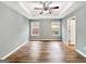 Spacious main bedroom with tray ceiling, wood floors, and natural light at 106 Oakwood Cir, Stockbridge, GA 30281