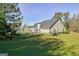 Well-maintained backyard showcasing a pergola, black metal fencing, and mature trees at 100 Clydesdale Ct, Tyrone, GA 30290