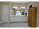 Primary bathroom featuring a large, double vanity sink with white cabinets and a wooden linen closet at 100 Clydesdale Ct, Tyrone, GA 30290