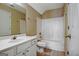 The bathroom has a single sink vanity, large mirror, and a tub and shower combination with neutral walls at 100 Clydesdale Ct, Tyrone, GA 30290