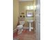 Cozy bathroom with a pedestal sink, toilet, decorative wall art, and a light-colored door at 100 Clydesdale Ct, Tyrone, GA 30290