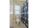 The bathroom features a floral shower curtain, toilet, and a window for light at 100 Clydesdale Ct, Tyrone, GA 30290