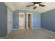 Cozy bedroom featuring plush carpeting, a ceiling fan, and access to an ensuite bathroom, creating a private retreat at 100 Clydesdale Ct, Tyrone, GA 30290