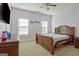 Comfortable bedroom with large windows, plush carpeting, and a stylish wooden bed frame at 100 Clydesdale Ct, Tyrone, GA 30290