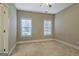 Cozy bedroom features neutral walls, carpeted floor, and large windows for natural light at 100 Clydesdale Ct, Tyrone, GA 30290