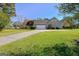 View of home showing driveway to attached garage and well-maintained lawn at 100 Clydesdale Ct, Tyrone, GA 30290