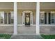 Front door with sidelights and a sign, framed by stately columns at 100 Clydesdale Ct, Tyrone, GA 30290