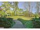 Lush front yard with mature trees and sidewalk at 100 Clydesdale Ct, Tyrone, GA 30290