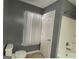 A clean bathroom with a neutral color scheme, featuring a shower-tub combination and large window at 106 Ne Ellis Dr # 106, Conyers, GA 30012