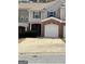 Two-story townhome with a brick garage and covered front porch, offering a convenient parking solution at 106 Ne Ellis Dr # 106, Conyers, GA 30012