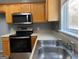 Well-equipped kitchen with a stainless steel range and microwave, complemented by natural wood cabinetry at 106 Ne Ellis Dr # 106, Conyers, GA 30012