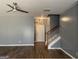 Open living area features hardwood floors, a ceiling fan, and a staircase leading to the upper level at 106 Ne Ellis Dr # 106, Conyers, GA 30012