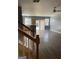 An open concept living space with hardwood floors, featuring a staircase and partial view of the kitchen at 106 Ne Ellis Dr # 106, Conyers, GA 30012