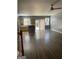 An open living and dining area with hardwood floors, a kitchen island, and natural light from windows at 106 Ne Ellis Dr # 106, Conyers, GA 30012
