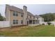 Spacious backyard featuring a sunroom, privacy fence, and lush green grass at 3338 Gardenside Walk, Loganville, GA 30052