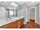 Bathroom with double vanity, full mirror, and separate tub/shower at 3338 Gardenside Walk, Loganville, GA 30052