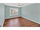 Comfortable bedroom features wood floors, a window, and a ceiling fan at 3338 Gardenside Walk, Loganville, GA 30052