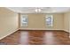 A well-lit bedroom with hardwood floors, natural light and a calming atmosphere at 3338 Gardenside Walk, Loganville, GA 30052