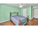 Bright bedroom boasts a ceiling fan, a window, and an entry door at 3338 Gardenside Walk, Loganville, GA 30052