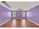 Spacious bedroom features two windows, wood floors, and a ceiling fan at 3338 Gardenside Walk, Loganville, GA 30052
