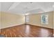 A spacious bedroom with tray ceiling, fan, and hardwood floors for comfort at 3338 Gardenside Walk, Loganville, GA 30052