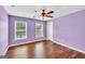 This bedroom features wood floors, neutral colors, and two bright windows at 3338 Gardenside Walk, Loganville, GA 30052