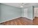 A cozy bedroom featuring hardwood floors, ceiling fan and a neutral color scheme at 3338 Gardenside Walk, Loganville, GA 30052