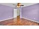 This bedroom features wood floors, neutral colors, and an entry door at 3338 Gardenside Walk, Loganville, GA 30052
