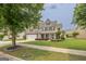 Inviting two-story home featuring a well-kept lawn and traditional design elements at 3338 Gardenside Walk, Loganville, GA 30052