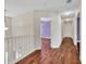 Upstairs hallway featuring hardwood floors, neutral paint, and recessed lighting at 3338 Gardenside Walk, Loganville, GA 30052