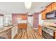 Kitchen with stainless steel appliances, granite countertops, and hardwood floors at 3338 Gardenside Walk, Loganville, GA 30052
