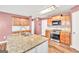 Kitchen features granite countertops, stainless steel appliances, and hardwood floors at 3338 Gardenside Walk, Loganville, GA 30052