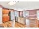 Kitchen with island, stainless steel appliances, and hardwood floors at 3338 Gardenside Walk, Loganville, GA 30052