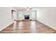 Open-concept living room featuring a cozy fireplace and durable hardwood floors at 3338 Gardenside Walk, Loganville, GA 30052