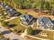 Expansive aerial view of a brick home with a lush lawn backing onto a wooded area in a desirable neighborhood at 6857 Louis Dr, Locust Grove, GA 30248
