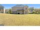 Expansive backyard with lush green grass and mature trees surrounding the property at 6857 Louis Dr, Locust Grove, GA 30248