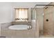 Bathroom showcasing a luxurious bathtub and a separate glass enclosed shower at 6857 Louis Dr, Locust Grove, GA 30248