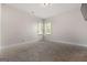 Carpeted bedroom featuring large windows and neutral decor at 6857 Louis Dr, Locust Grove, GA 30248