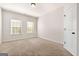 Cozy carpeted bedroom with two windows letting in natural light at 6857 Louis Dr, Locust Grove, GA 30248