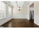 Elegant dining room with coffered ceilings, dark hardwood floors, and stainless steel refrigerator at 6857 Louis Dr, Locust Grove, GA 30248
