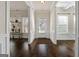 Inviting foyer with dark hardwood floors, detailed trim, and a clear view of the front door at 6857 Louis Dr, Locust Grove, GA 30248